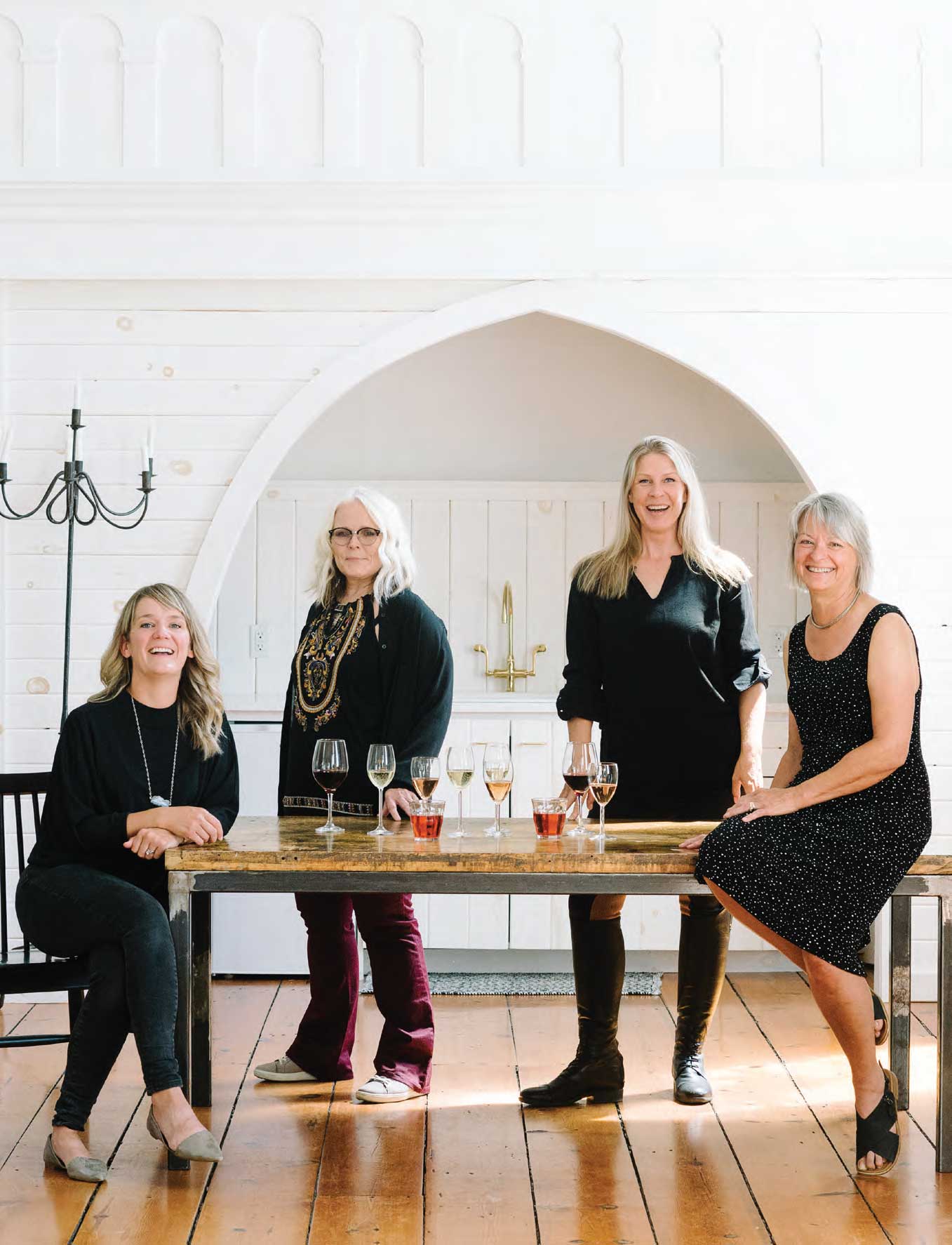 Astrid Young, Marlise Ponzo, Bev Carnahan and Sara Boyd sitting at a table drinking wine