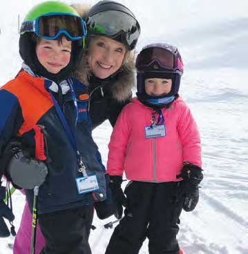 Jane Kelly with kids skiing